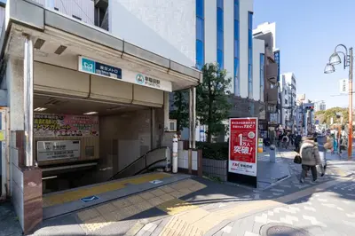 a street with people walking in front of a building at Retaw Hills WASEDA in Tokyo