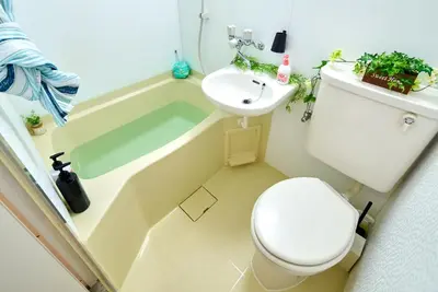 a bathroom with a toilet and a sink and a tub at SC 103 Cozy Private Stay with Loft Near Station Free WiFi in Tokyo