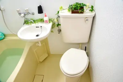 a bathroom with a toilet and a sink with plants on it at SC 103 Cozy Private Stay with Loft Near Station Free WiFi in Tokyo