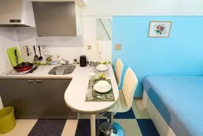 a small kitchen with a sink and a bed at SC 103 Cozy Private Stay with Loft Near Station Free WiFi in Tokyo