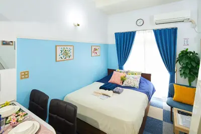 a bedroom with a bed with blue walls at SC 103 Cozy Private Stay with Loft Near Station Free WiFi in Tokyo