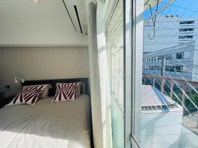 a bedroom with a bed next to a large window at JUN-shinjuku 4F-SJ0094 in Tokyo