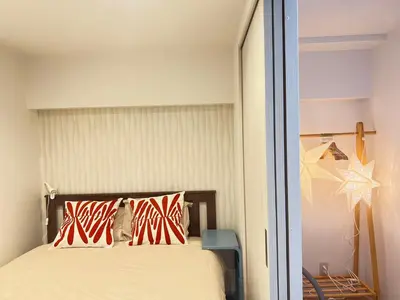 a bedroom with a bed with red and white pillows at JUN-shinjuku 4F-SJ0094 in Tokyo