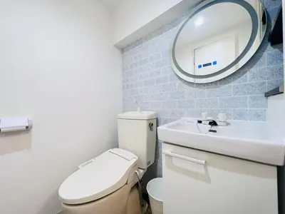 a bathroom with a toilet and a sink and a mirror at JUN-shinjuku 4F-SJ0094 in Tokyo