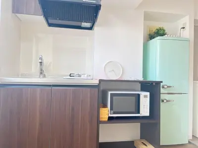 a kitchen with a microwave and a refrigerator at JUN-shinjuku 4F-SJ0094 in Tokyo
