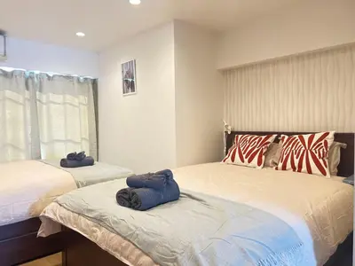 a bedroom with two beds with towels on them at JUN-shinjuku 4F-SJ0094 in Tokyo