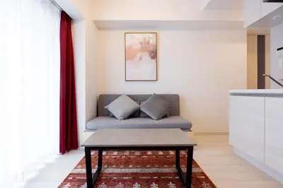 a living room with a couch and a table at Noble Park KINSHICHO in Tokyo