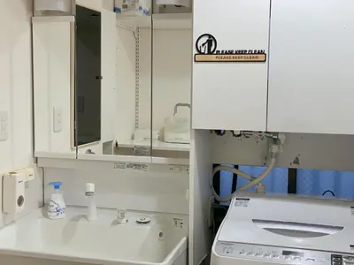 a white kitchen with a sink and a mirror at Asakusa Inn \u5c4b\u4e0a\u30d0\u30eb\u30b3\u30cb\u30fc\u4ed8\u304d100m2\u5e83\u3005\u5feb\u9069\u4e00\u68df\u30cf\u30a6\u30b9 in Tokyo