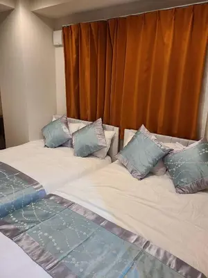 two beds sitting next to each other in a bedroom at 301\u53f7N\uff0b\u30db\u30c6\u30eb in Tokyo