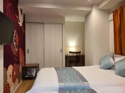 a bedroom with a bed and a sliding door at 301\u53f7N\uff0b\u30db\u30c6\u30eb in Tokyo
