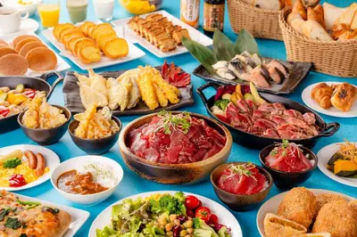 a table filled with different types of food on plates at Shinjuku Washington Hotel Annex in Tokyo