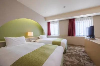 a hotel room with two beds and a flat screen tv at Shinjuku Washington Hotel Annex in Tokyo