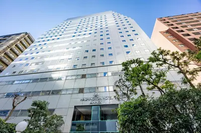 a tall white building with trees in front of it at Shinjuku Washington Hotel Annex in Tokyo