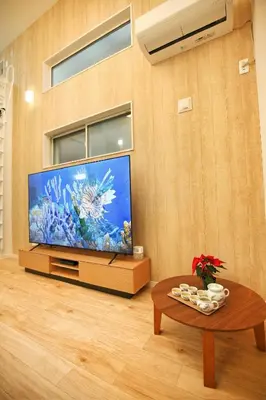 a living room with a large television with an aquarium at kameido k hotel in Tokyo