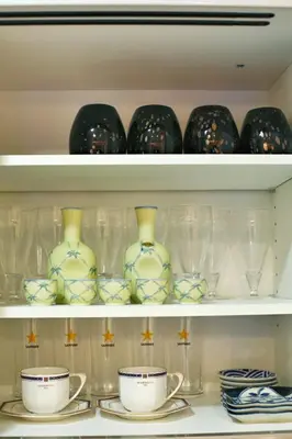 a shelf filled with vases and cups and plates at kameido k hotel in Tokyo