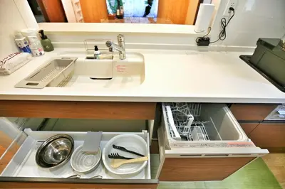 a kitchen counter with a sink and a dishwasher at kameido k hotel in Tokyo