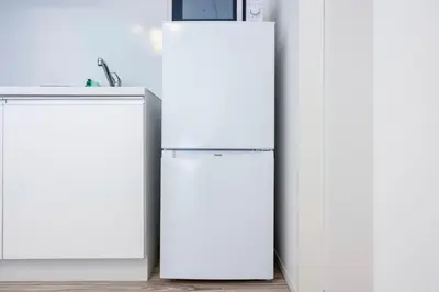 two white refrigerators standing next to each other in a kitchen at \u30eb\u30cd\u30b5\u30f3\u30b9\u30b3\u30fc\u30c8\u81ea\u7531\u304c\u4e18 in Tokyo
