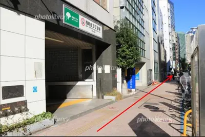 a city street with a building with a parking garage at Shibuya Honmachi Hana House in Tokyo