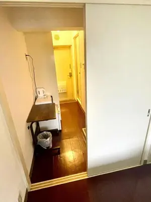 an empty room with a hallway with a table and a mirror at Shibuya Honmachi Hana House in Tokyo