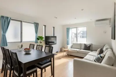 a living room with a table and a couch at Relastay Kamata in Tokyo