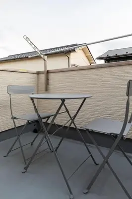a table and two chairs in front of a building at Relastay Kamata in Tokyo