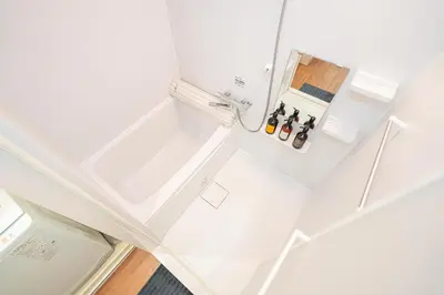 an overhead view of a white kitchen with bottles of wine at KYARA Hotel\u30df\u30b9\u30df301 in Tokyo