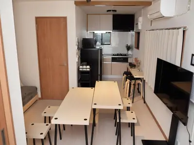 a small kitchen with two tables and a dining room at Lido North Shinagawa in Tokyo