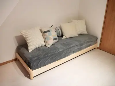 a couch with pillows on it in a room at Lido North Shinagawa in Tokyo