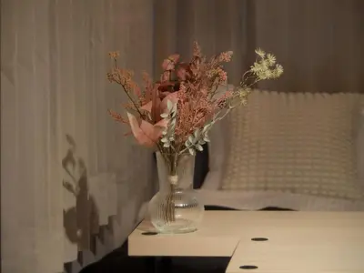 a vase filled with flowers sitting on a table at Lido North Shinagawa in Tokyo