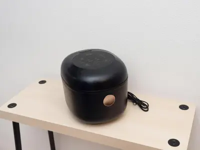 a black device sitting on top of a wooden table at Lido North Shinagawa in Tokyo