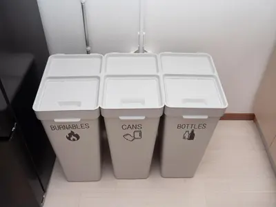two white trash cans sitting next to each other at Lido North Shinagawa in Tokyo