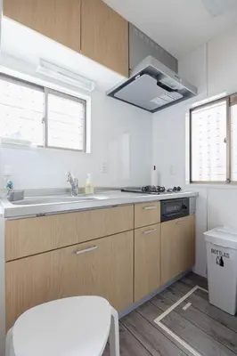a kitchen with wooden cabinets and a sink and a stove at Lido East Shinagawa\u3000 in Tokyo