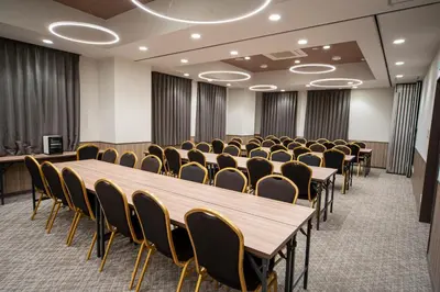 a conference room with wooden tables and chairs at Hotel Il Fiore Kasai Annex in Tokyo
