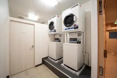 a laundry room with two washer and dryer machines at Hotel Il Fiore Kasai Annex in Tokyo