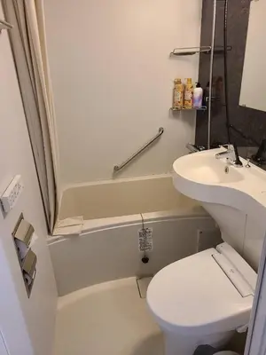 a white bathroom with a sink and a toilet at 302\u53f7\uff2e\uff0b\u30db\u30c6\u30eb in Tokyo