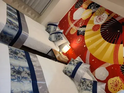 a bedroom with two beds and an umbrella on the wall at 303\u53f7\uff2e\uff0b\u30db\u30c6\u30eb in Tokyo