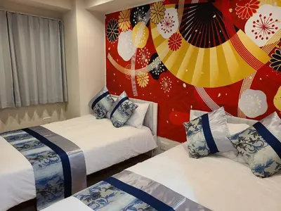 a hotel room with two beds and a wall with avertisement at 303\u53f7\uff2e\uff0b\u30db\u30c6\u30eb in Tokyo