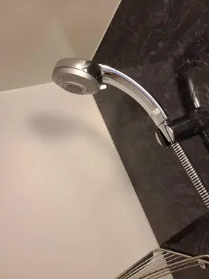 a shower head in a bathroom with a sink at 303\u53f7\uff2e\uff0b\u30db\u30c6\u30eb in Tokyo