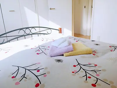 a bedroom with a bed with towels on it at Tokyo Center Ikebukuro Family villa quiet 4BR group stay & parking near JR in Tokyo