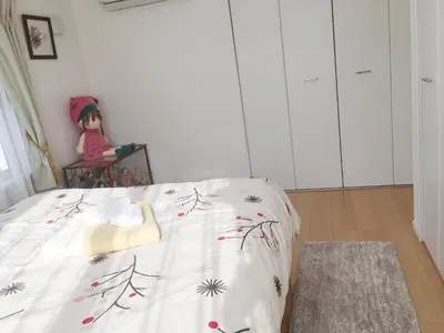 a bedroom with a bed with a blanket with flowers at Tokyo Center Ikebukuro Family villa quiet 4BR group stay & parking near JR in Tokyo