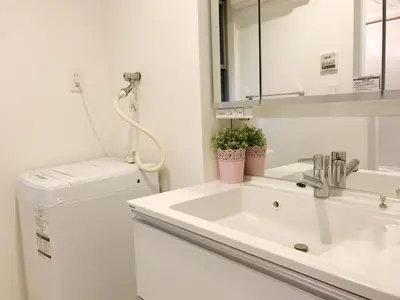 a bathroom with a sink and a washing machine at Tokyo Center Ikebukuro Family villa quiet 4BR group stay & parking near JR in Tokyo
