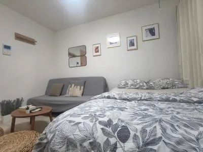 a bedroom with a bed and a couch at \u30c6\u30a3\u30a8\u30e9\u5317\u6c60\u888b in Tokyo