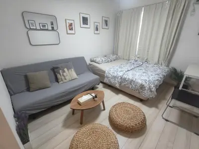 a living room with a couch and a bed at \u30c6\u30a3\u30a8\u30e9\u5317\u6c60\u888b in Tokyo