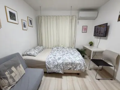 a bedroom with a bed and a desk and a couch at \u30c6\u30a3\u30a8\u30e9\u5317\u6c60\u888b in Tokyo