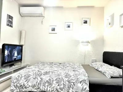 a small room with a bed and a tv at \u30c6\u30a3\u30a8\u30e9\u5317\u6c60\u888b in Tokyo
