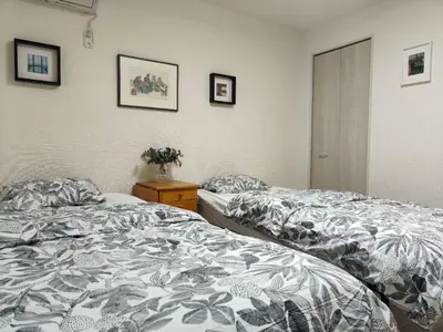 two beds sitting next to each other in a bedroom at \u30c6\u30a3\u30a8\u30e9\u5317\u6c60\u888b in Tokyo