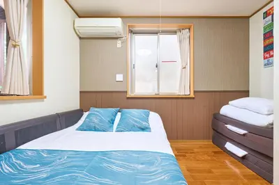 a small room with a bed and a window at J-2S JR Yamanote Komagome, 3 storey 101sq 4BR, FreePark in Tokyo