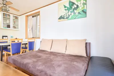 a living room with a couch and a dining room at J-2S JR Yamanote Komagome, 3 storey 101sq 4BR, FreePark in Tokyo