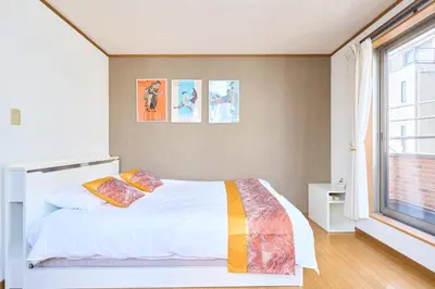 a bedroom with a bed and a window at J-2S JR Yamanote Komagome, 3 storey 101sq 4BR, FreePark in Tokyo