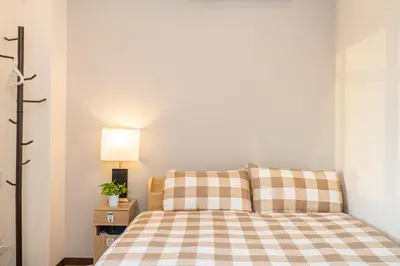 a bedroom with a bed with a checkered blanket at Asakusa,Ginza,Ueno,Skytree,Stn&Conv 1min ,Family suite,45 Mins to Airport,Kiyoka Villa 清禾 in Tokyo